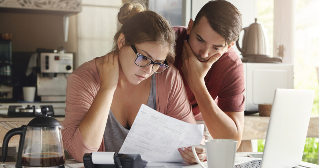 A couple reviewing paperwork after a crash