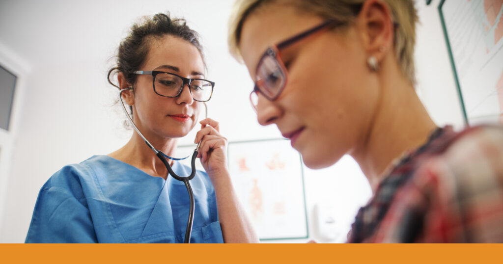 A woman being examined by a medical professional after a crash