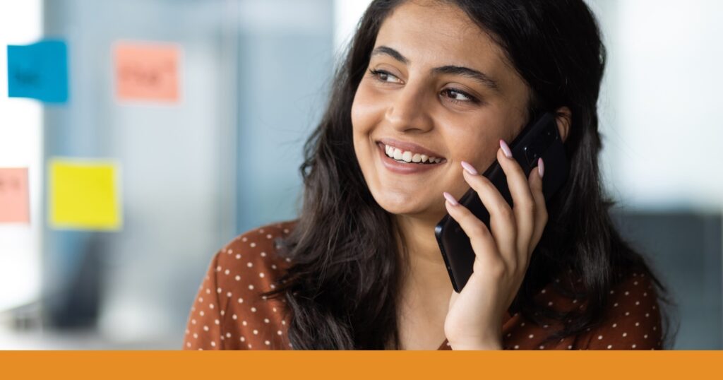 a woman smiling while talking on the phone about a car accident settlement