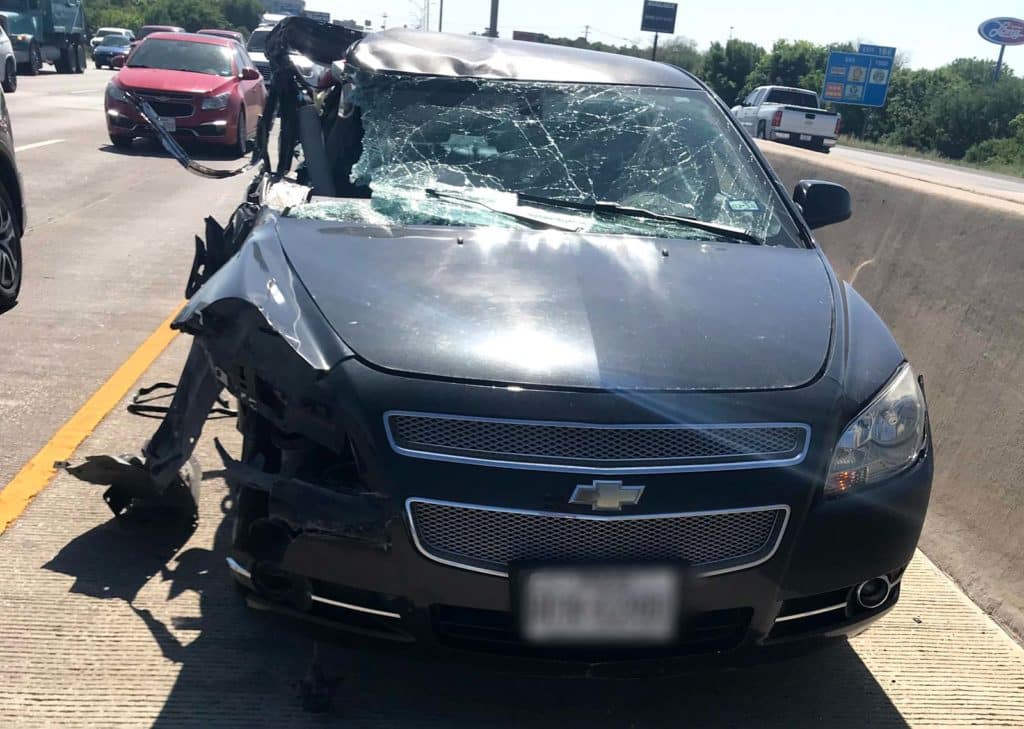 Inside view of a car after a collision with an 18-wheeler.