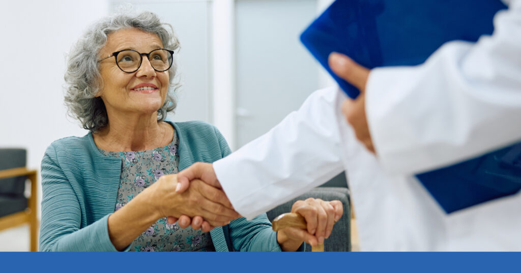 A woman shaking hands with a medical professional