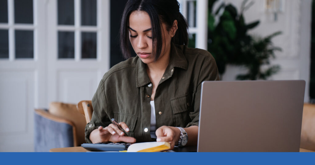 A woman reviewing notes and calculations