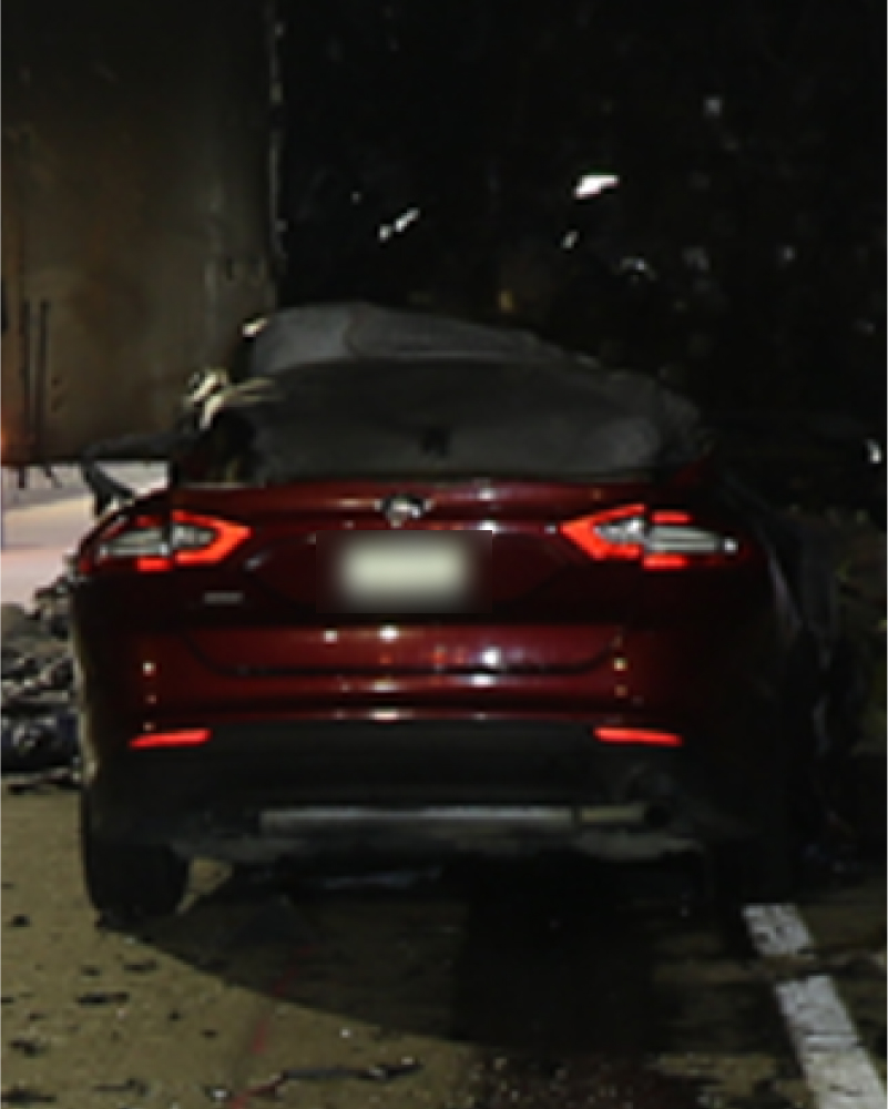 Rear view of a car that crashed into a tractor trailer