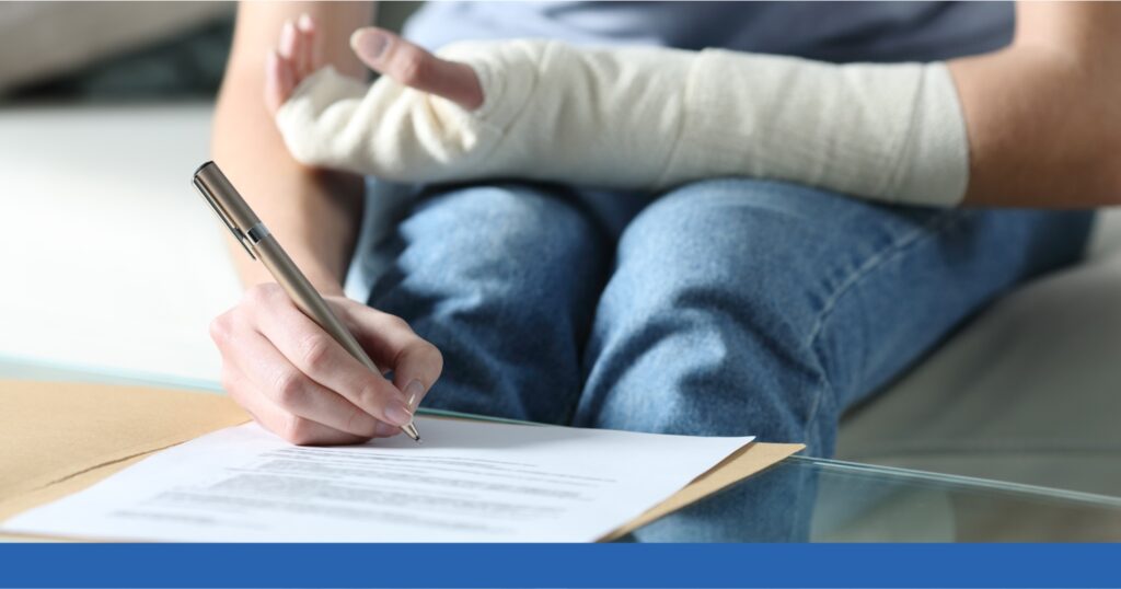 a person with an arm injury writing on a paper