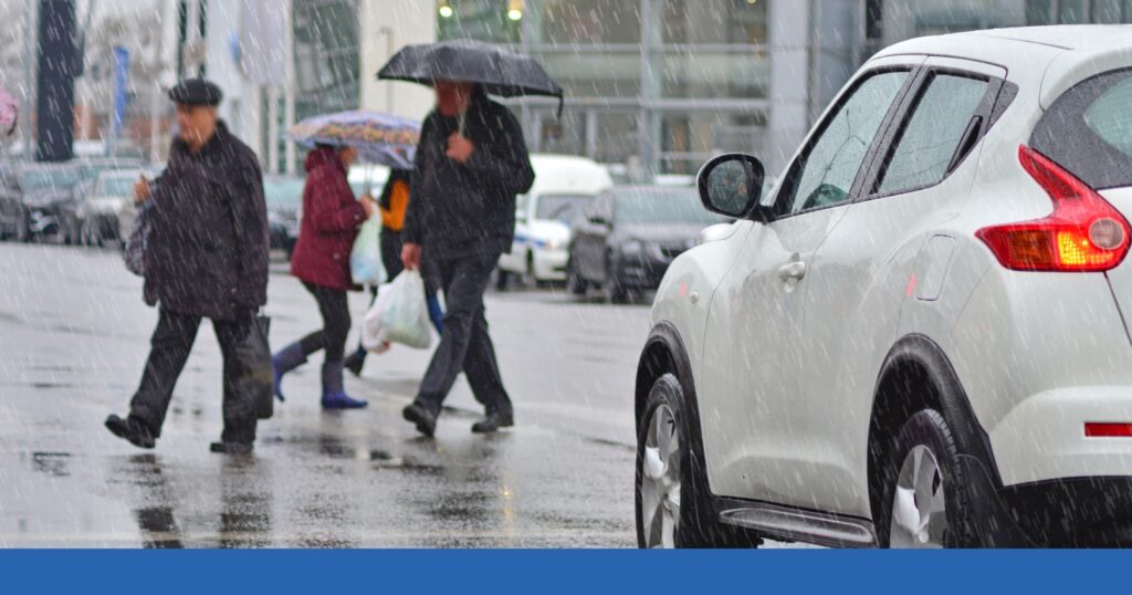 pedestrians walking in the rain with umbrellas