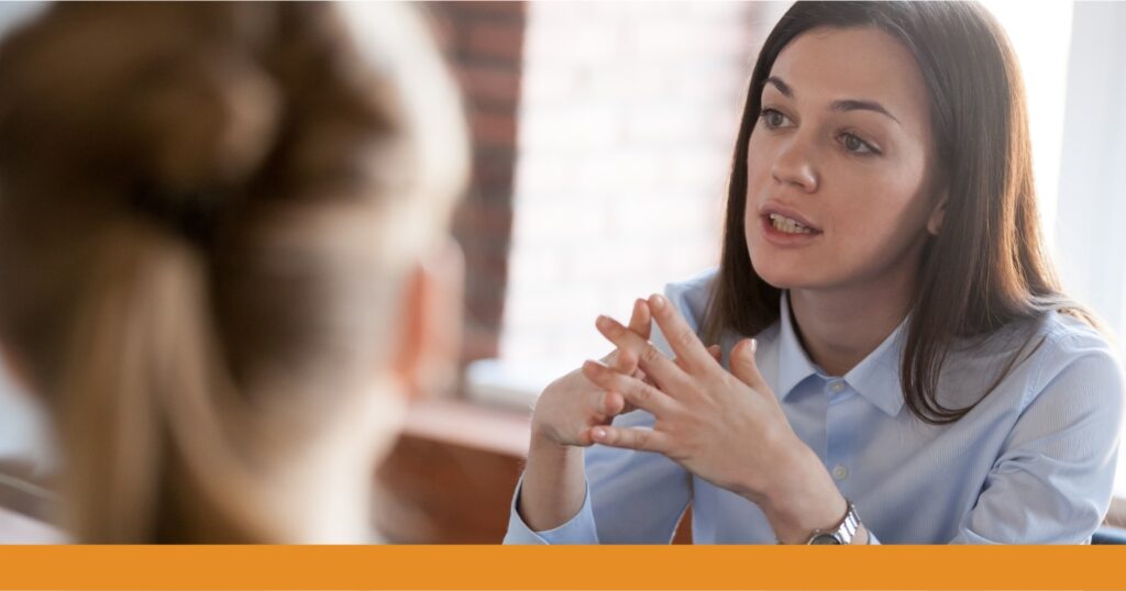 a woman talking to another woman