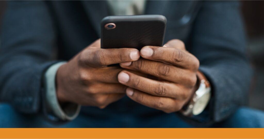a close-up of a man's hands holding a phone