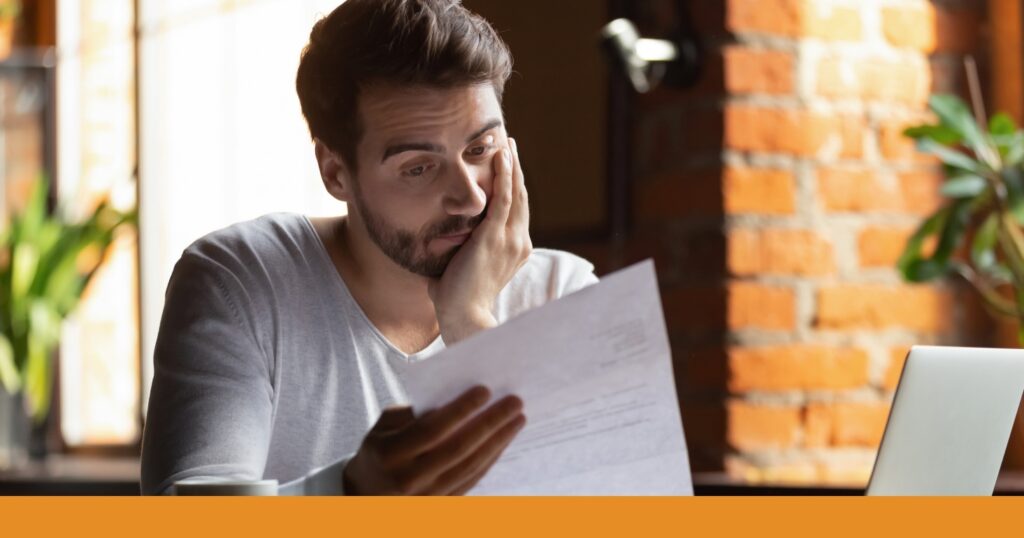 a man reviewing paperwork after an insurance claim