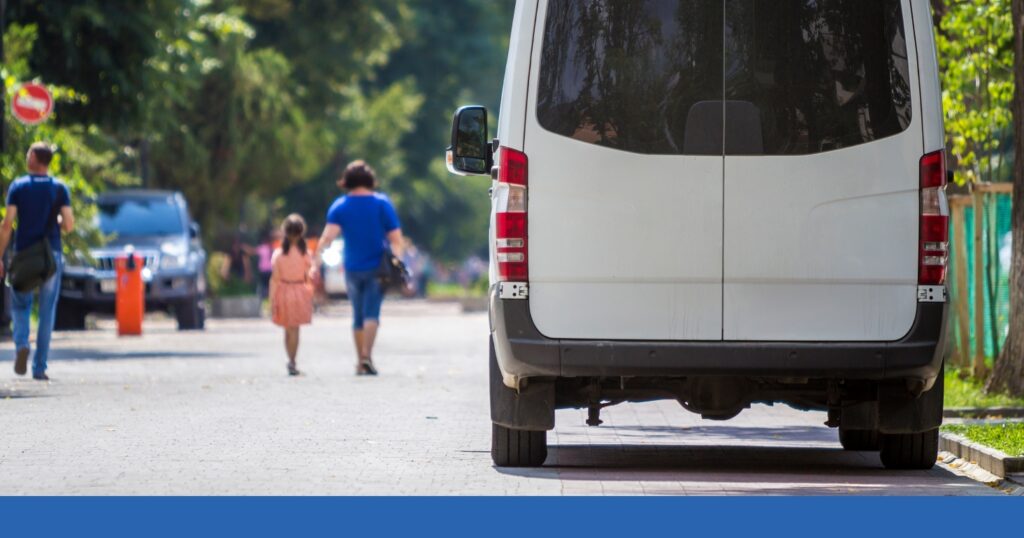 rear view of a commercial delivery vehicle driving on the road