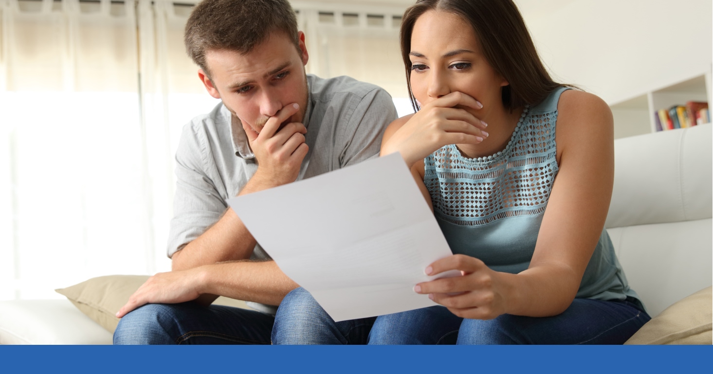 two people reading a paper about a workplace settlement