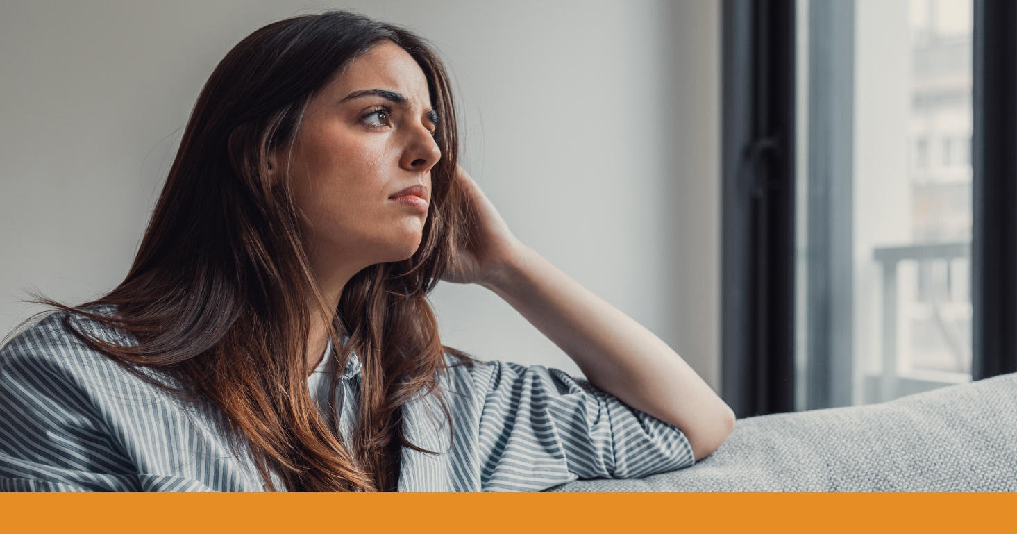 a woman looking through a window with a concerned expression