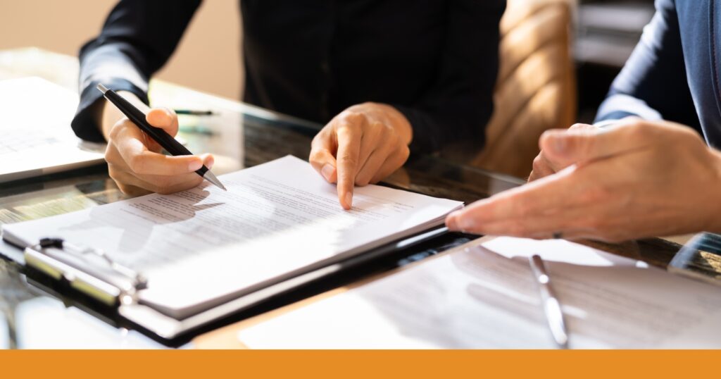 two people going over paperwork during an intake process for hiring a lawyer