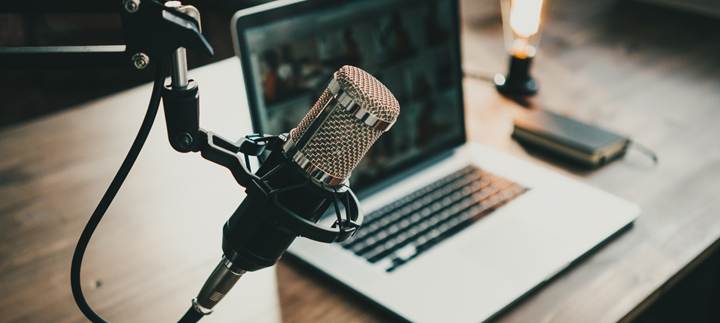 a microphone and laptop being used for a podcast