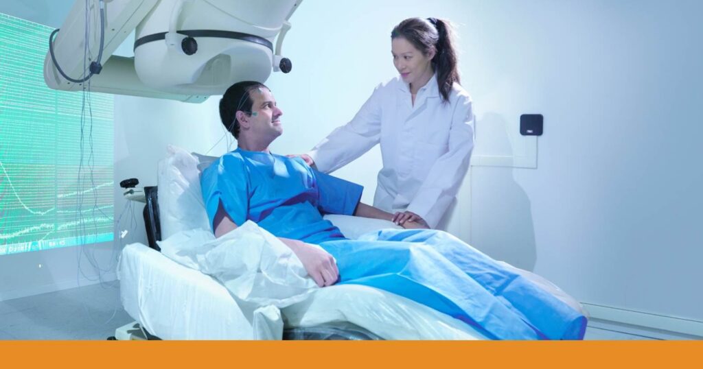 a man sitting in a medical chair for a medical procedure for a TBI