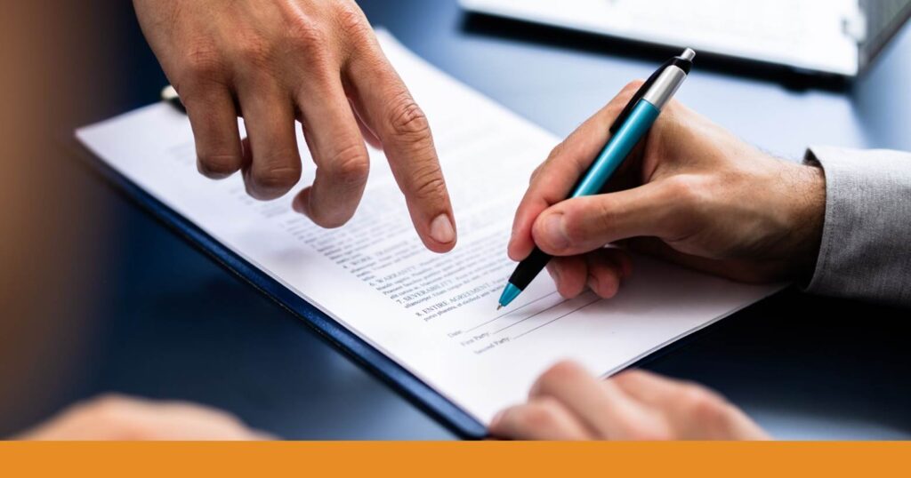 two people going over paperwork when hiring a lawyer