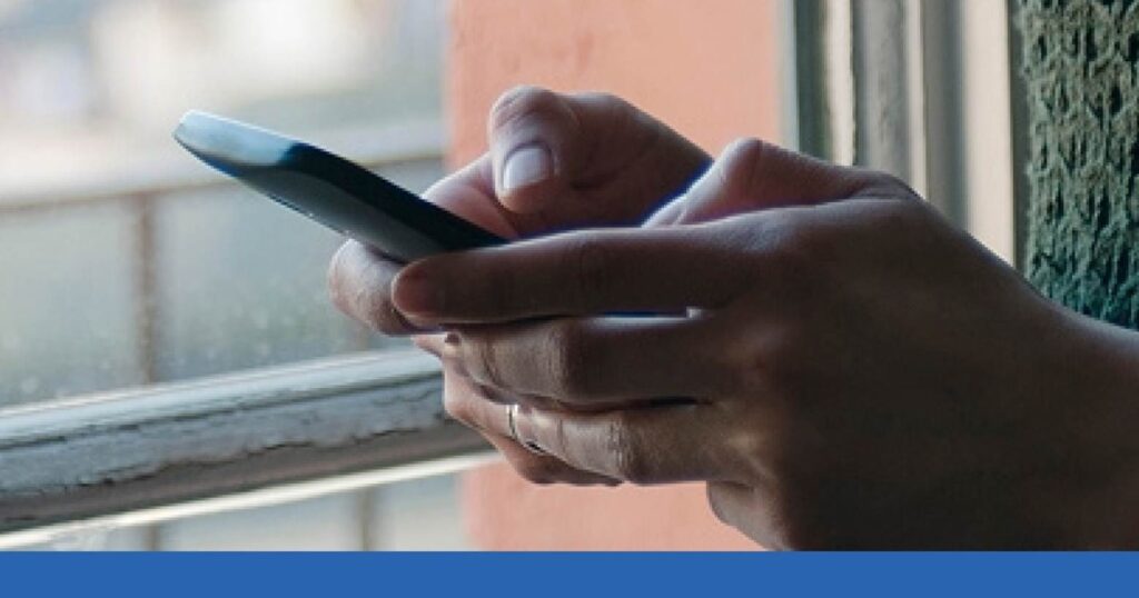 a person holding a cell phone making a call to a lawyer