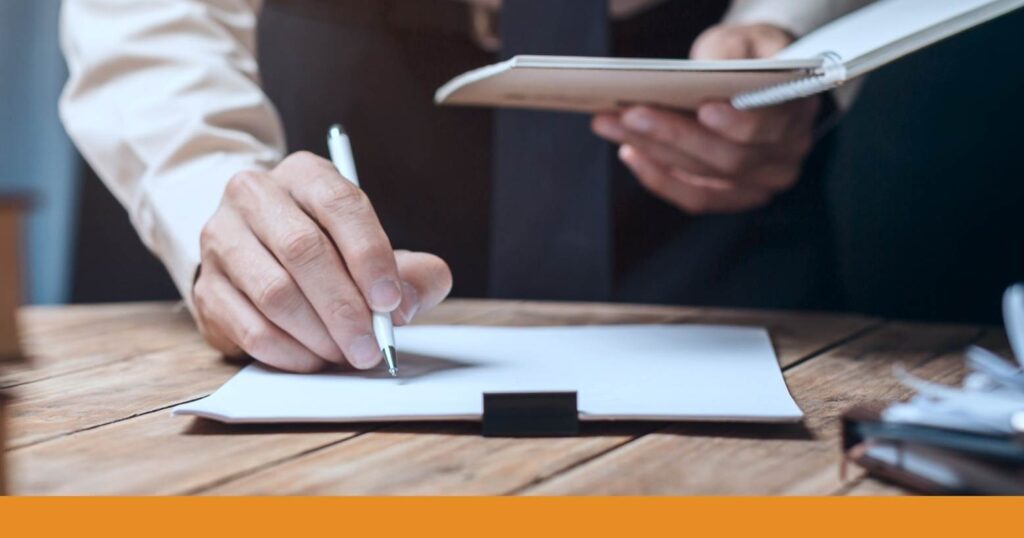 closeup of an accident lawyer taking notes