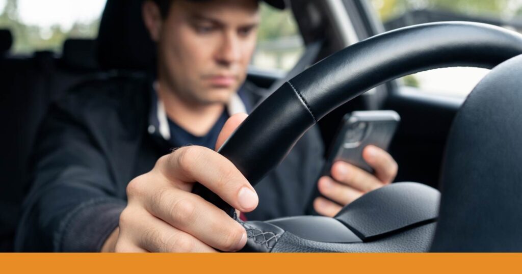 a driver using a handheld phone while driving