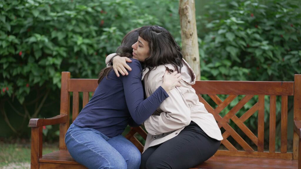 two people embracing while one comforts the other after a personal injury case