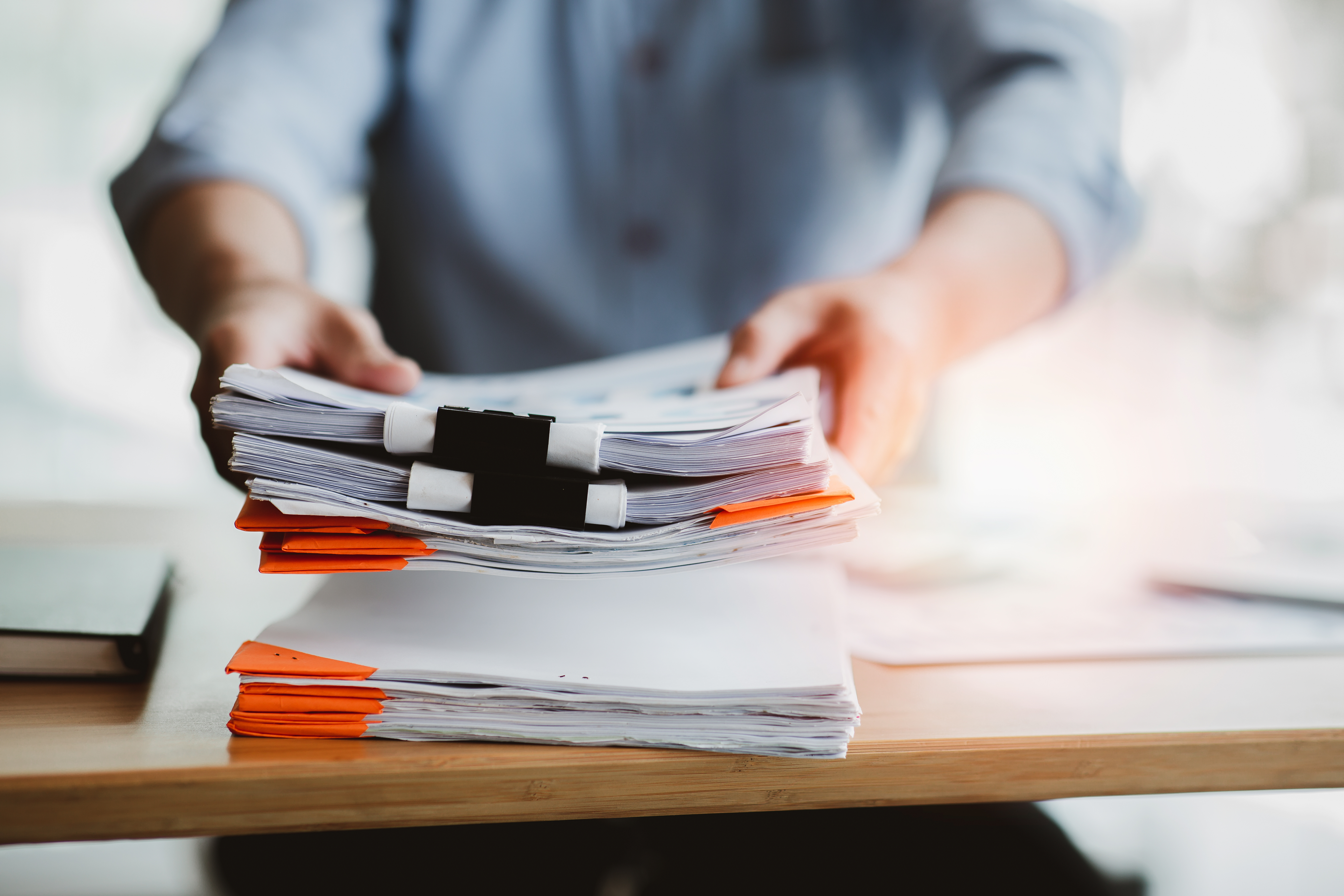 Why having a San Antonio car accident attorney matters after a crash 3 Legal documents and case files being organized and handed over for personal injury claim review