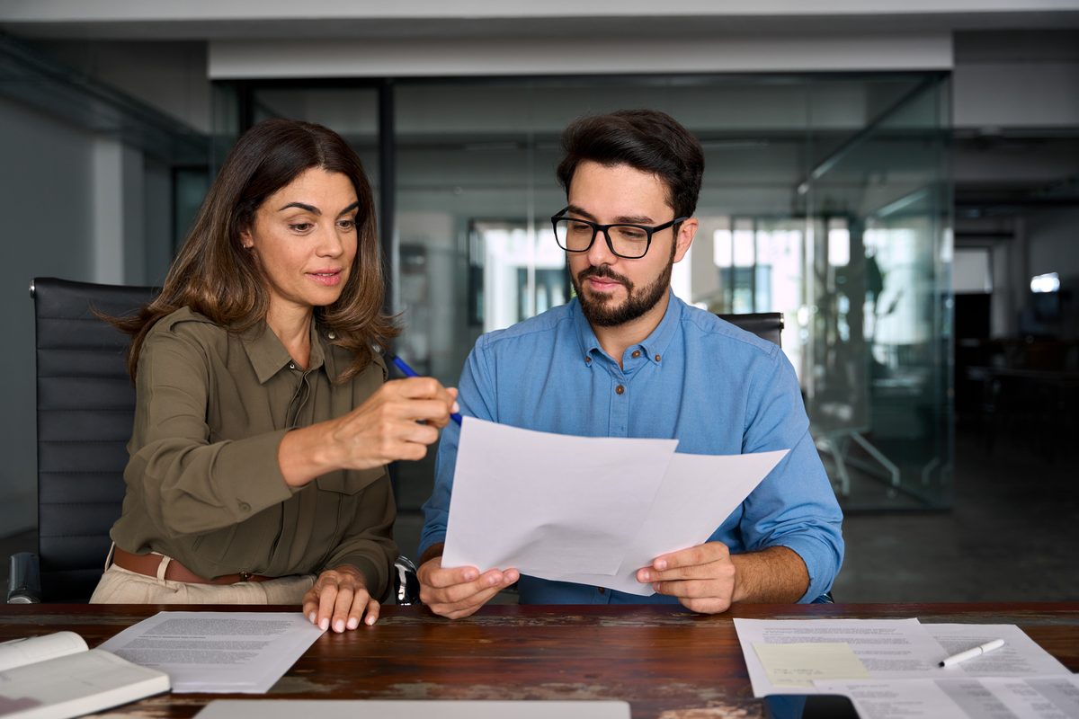 Advisor and client reviewing insurance and injury claim documents together during a consultation