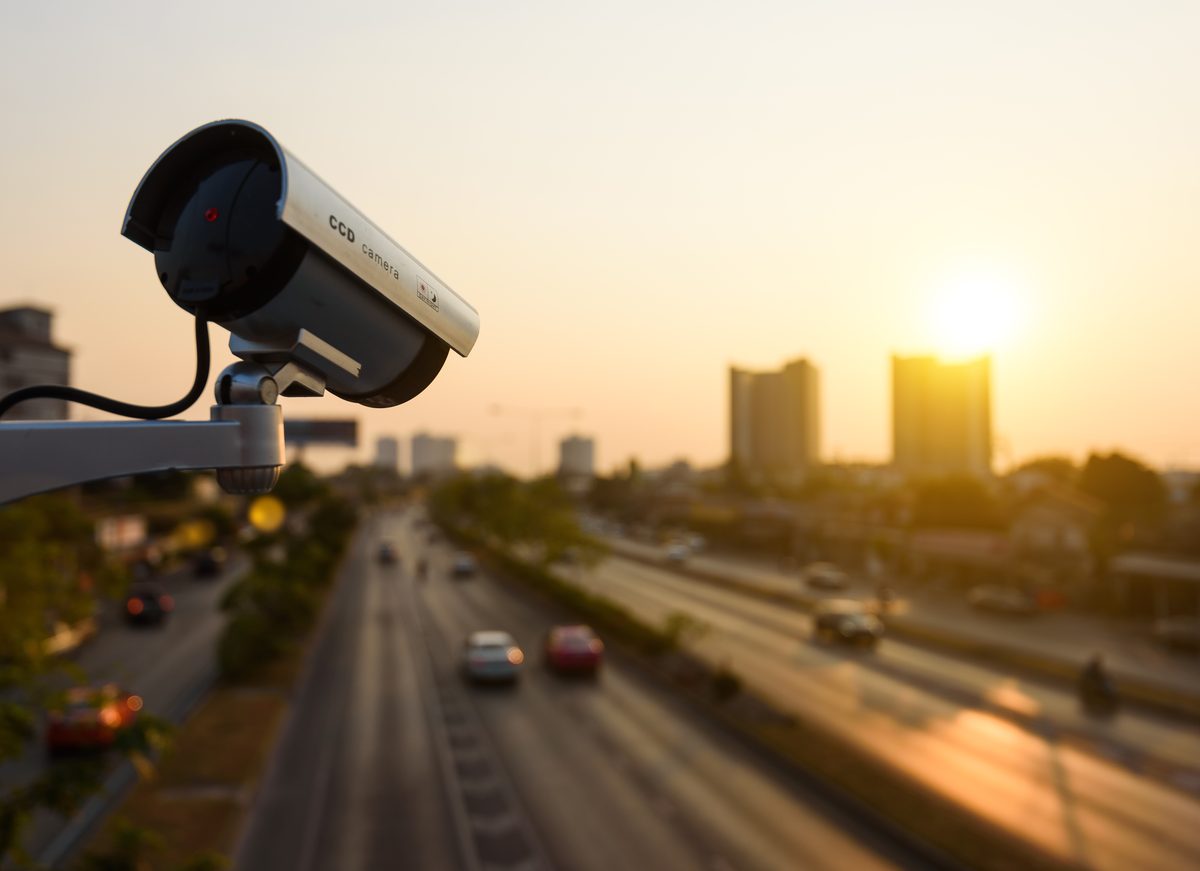Traffic surveillance camera overlooking a highway at sunset, footage that can help document an intersection crash